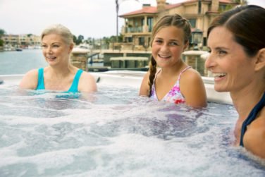 Three ladies laughing in hot tub