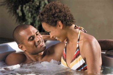 Couple laughing and relaxing in hot tub