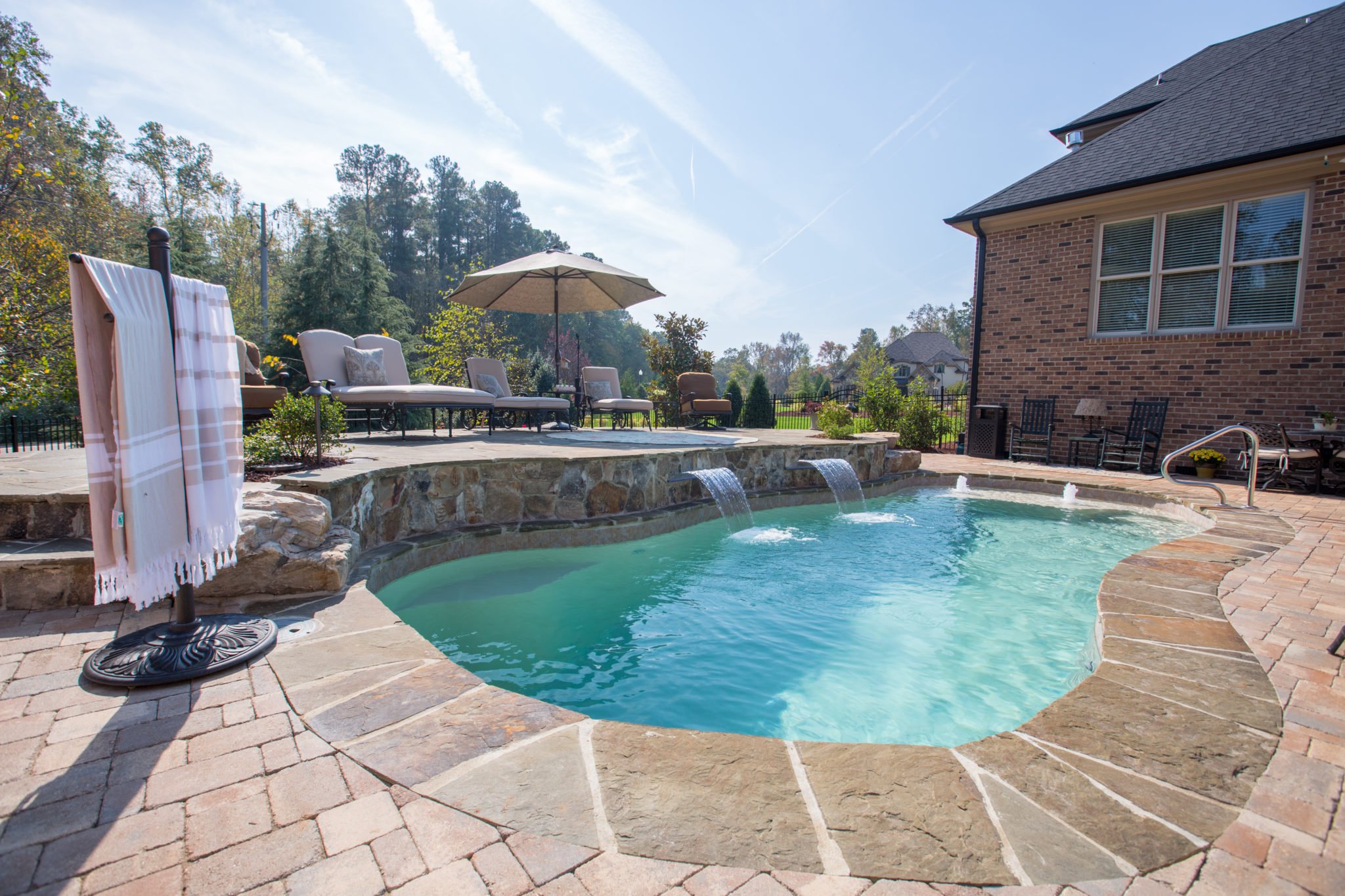 Rising sun pools and spas outdoor pool with waterfalls