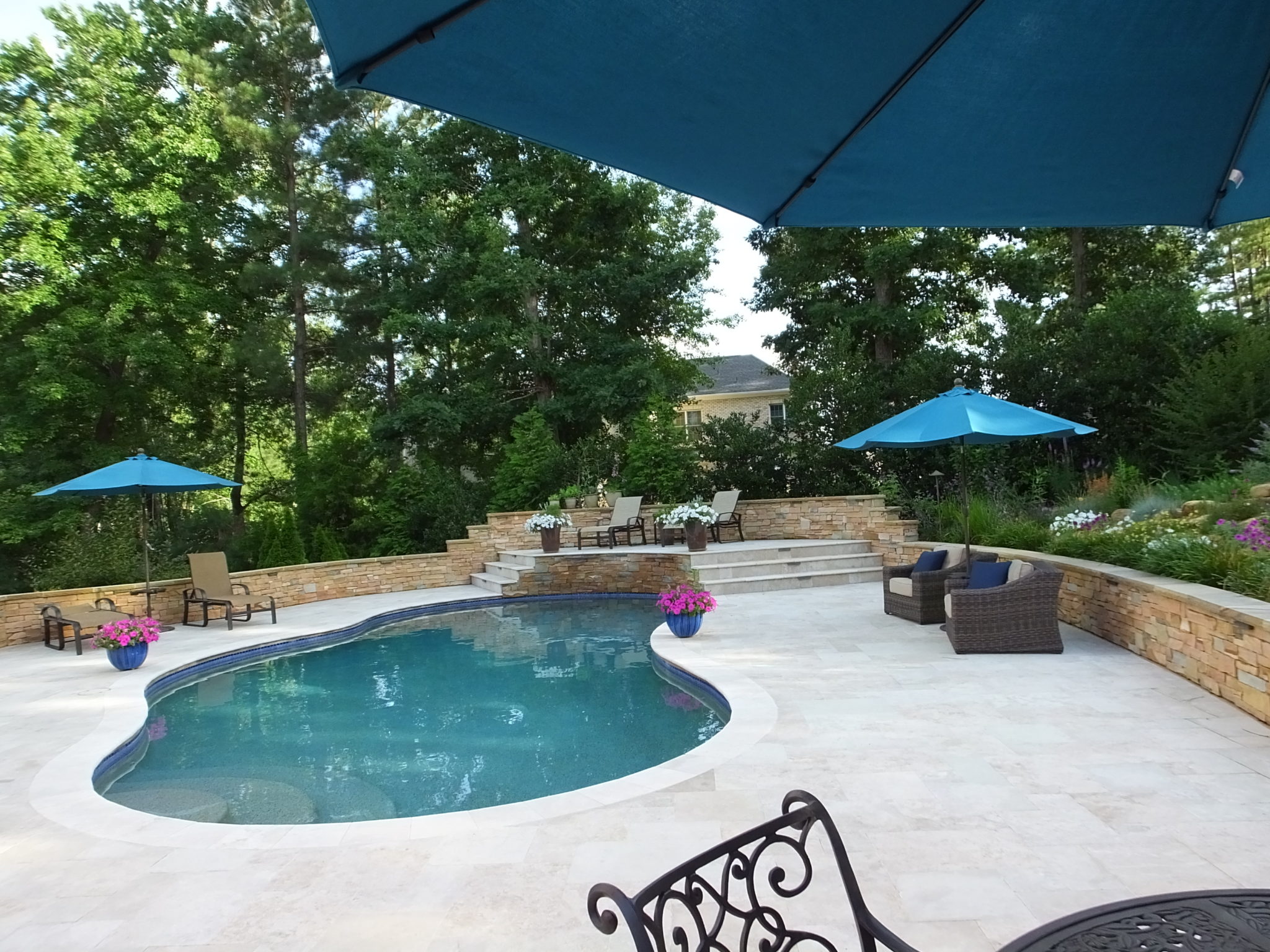 Rising sun pools and spas backyard pool with umbrellas