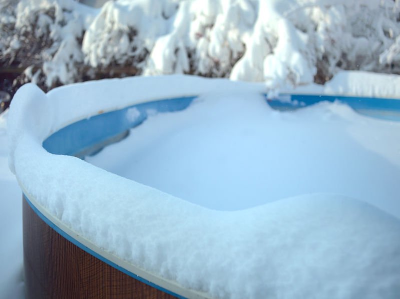 rising sun pools swimming pool covered with ice and snow in a cold winter day