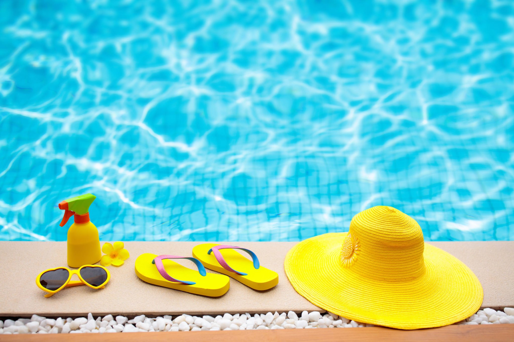 Sun Hat and Flip Flops by Pool | Rising Sun Pools and Spas