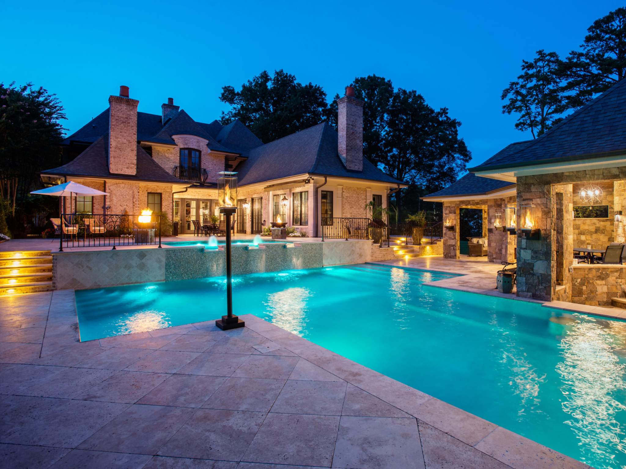 Concrete pool in the backyard of a luxury home.