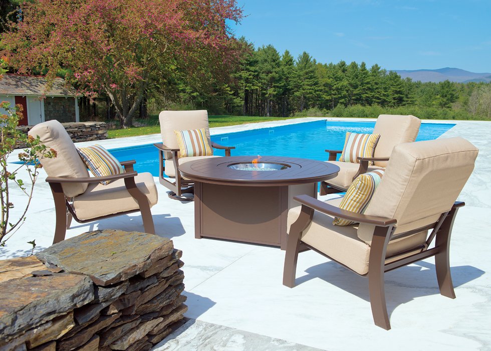 Rising Sun Pools designed poolside outdoor living space with firepit and patio furniture.